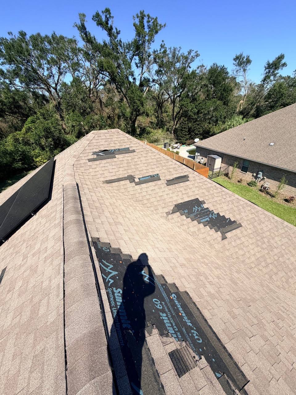 Roofer repairing a leak and flashing on a roof in Pinellas County, FL.