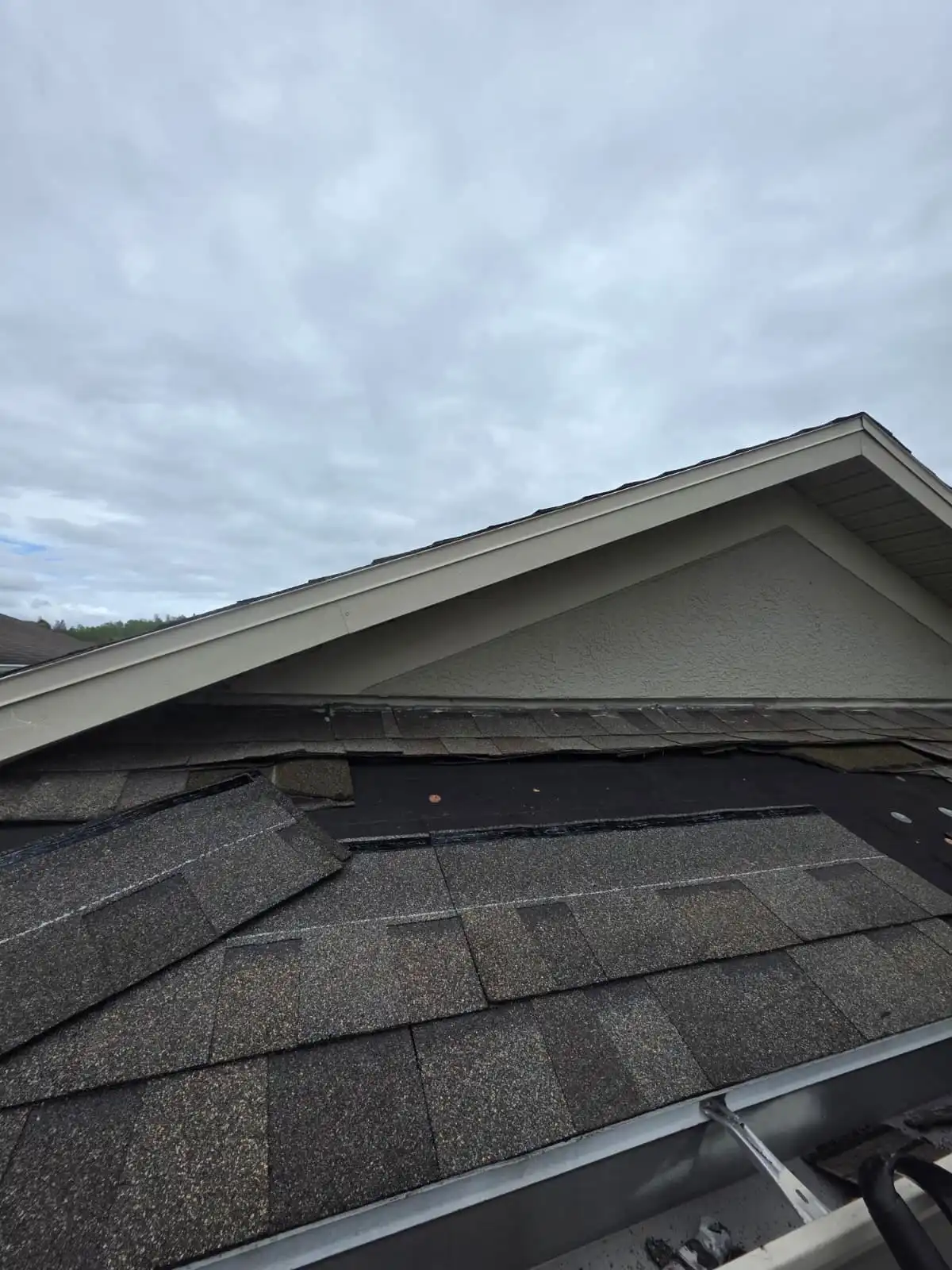 Roofer repairing a leak and flashing on a roof in Pasco County, FL.